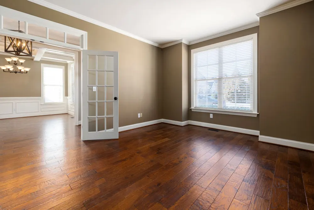 Hardwood flooring — bright empty room large windows — near Cerritos, CA