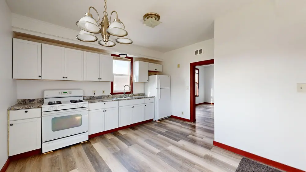 Laminate flooring — bright kitchen white cabinets — Laminate Flooring by OC Floor Guy