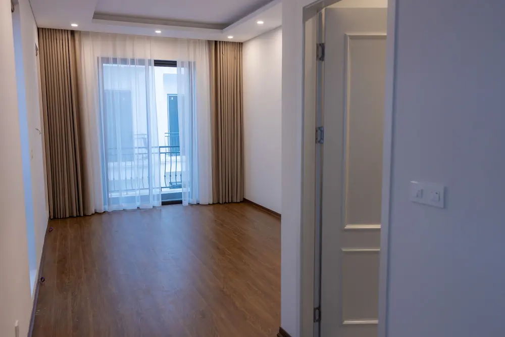 Luxury vinyl plank flooring — bright empty room balcony — flooring installed near Orange, CA