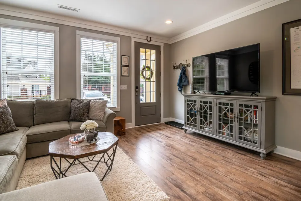 Luxury vinyl plank flooring — bright living room interior sofa t — flooring installed near Irvine, CA