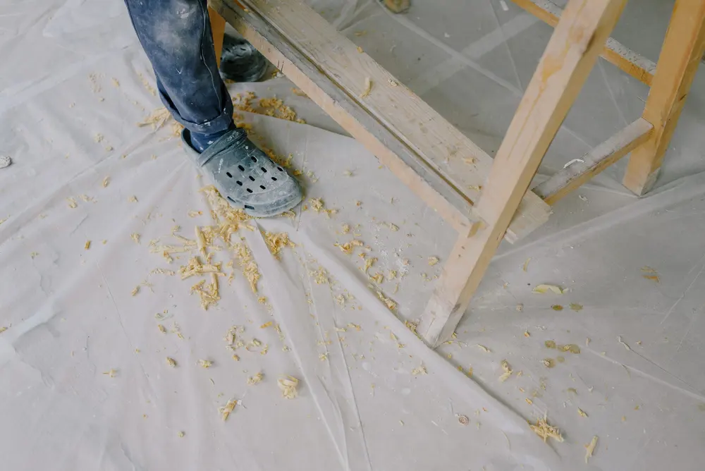 Concrete subfloor being assessed before flooring installation